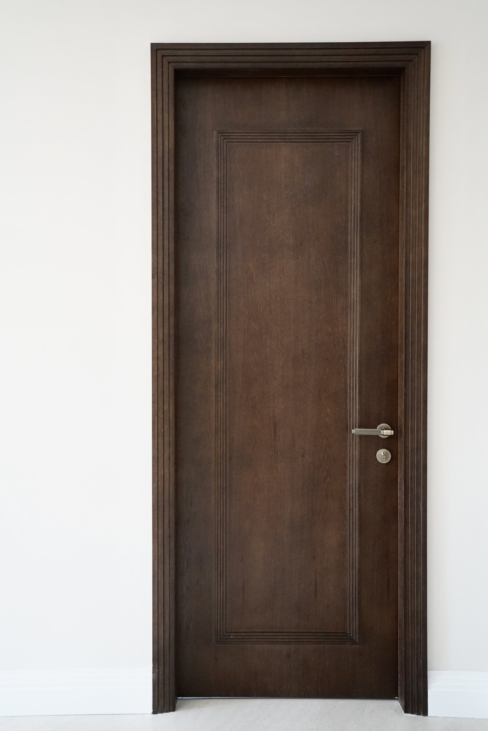 Dark walnut single-panel door with lever handle