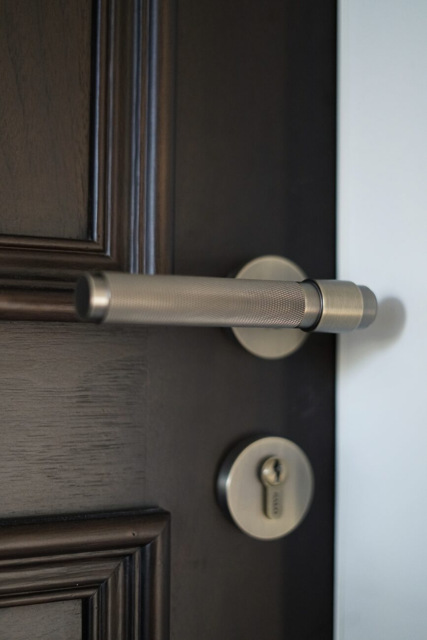 Knurled lever handle on walnut door